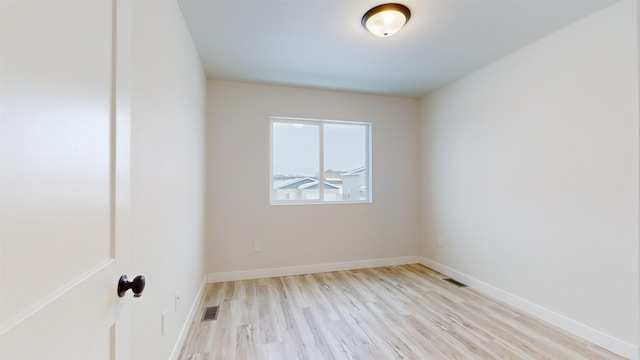 spare room with light wood-type flooring