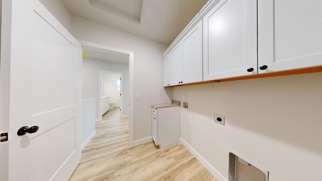 washroom featuring cabinets, hookup for a washing machine, light wood-type flooring, and electric dryer hookup