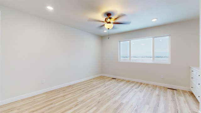 spare room with light hardwood / wood-style flooring and ceiling fan