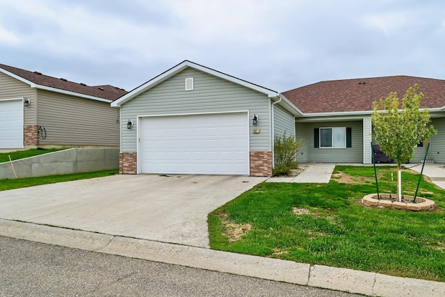 ranch-style home featuring a garage and a front yard