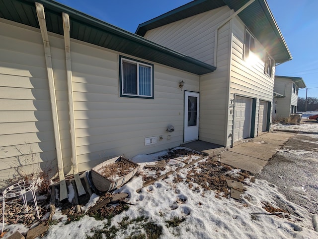 rear view of property with a garage