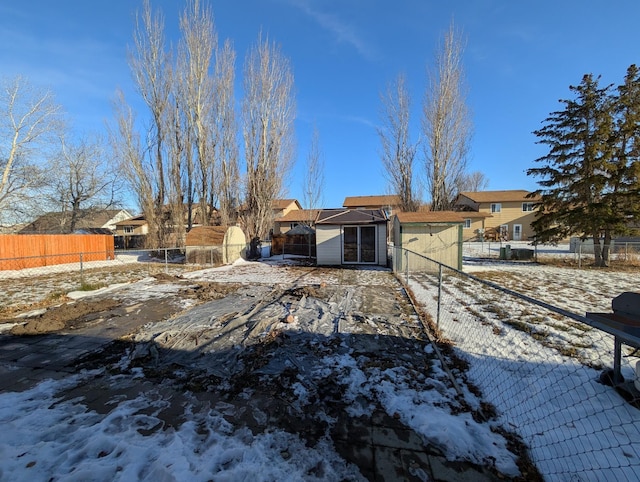 view of snow covered rear of property