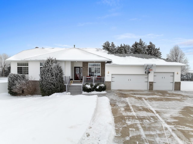 single story home with covered porch and a garage