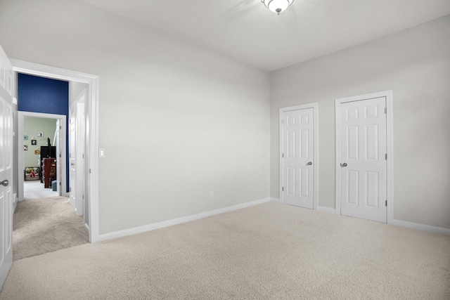 unfurnished bedroom featuring light carpet