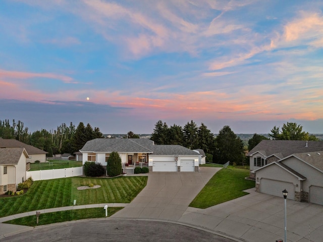 ranch-style house with a yard and a garage