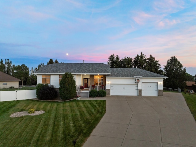 ranch-style home featuring a yard and a garage