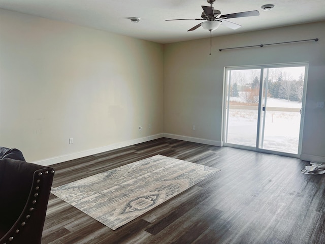 spare room with ceiling fan and dark hardwood / wood-style flooring