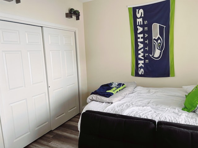 bedroom featuring dark hardwood / wood-style flooring and a closet