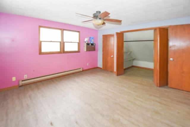 unfurnished bedroom featuring baseboard heating