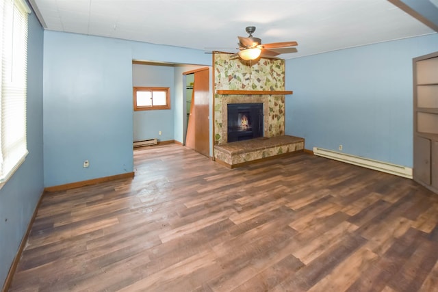 unfurnished living room with ceiling fan, dark hardwood / wood-style flooring, a wood stove, and baseboard heating