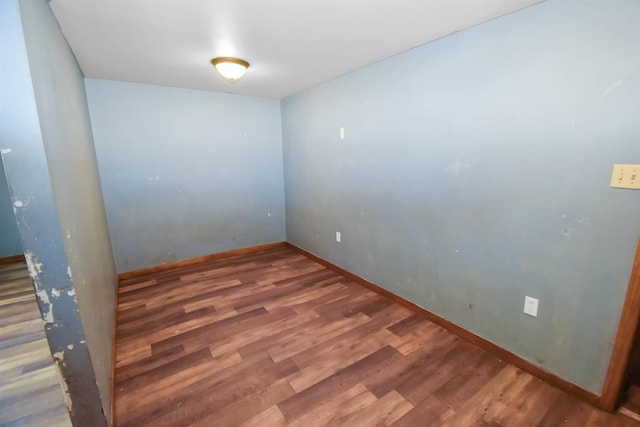 unfurnished room with wood-type flooring