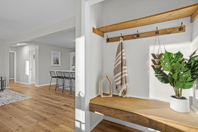 mudroom featuring hardwood / wood-style floors and beam ceiling