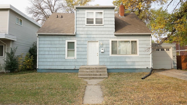 view of front of house featuring a garage and a front yard