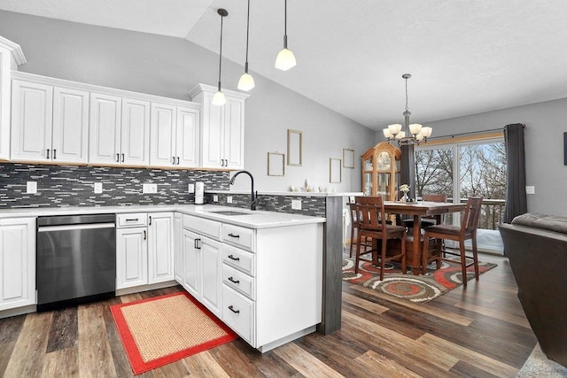 kitchen with lofted ceiling, white cabinetry, and sink