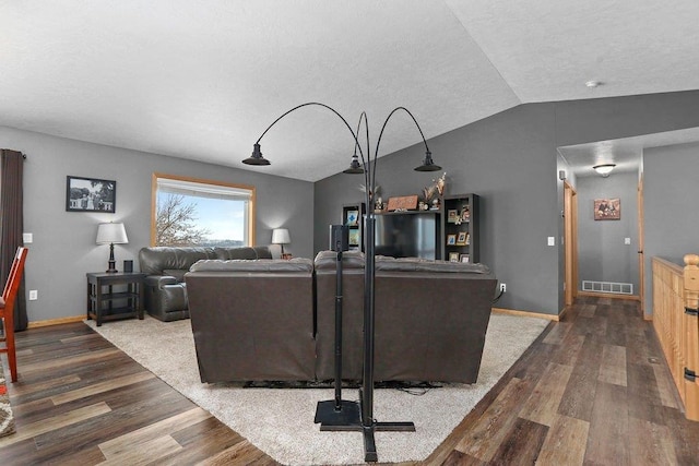 living room featuring lofted ceiling and dark hardwood / wood-style floors