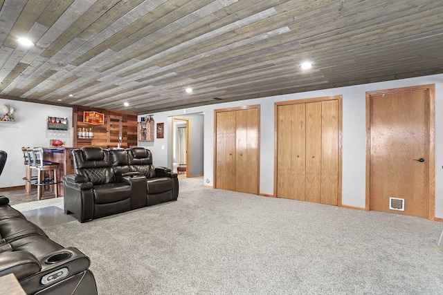 home theater featuring wood ceiling, indoor bar, and carpet flooring