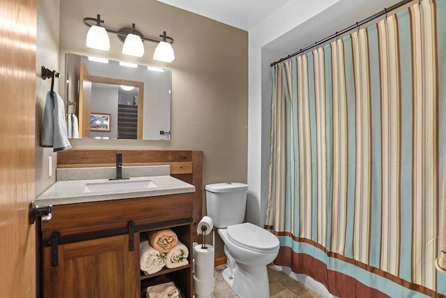 bathroom featuring tile patterned floors, vanity, and toilet