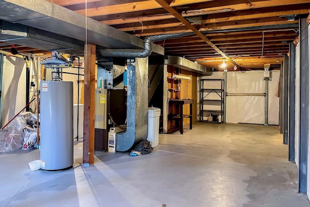 basement featuring water heater and heating unit