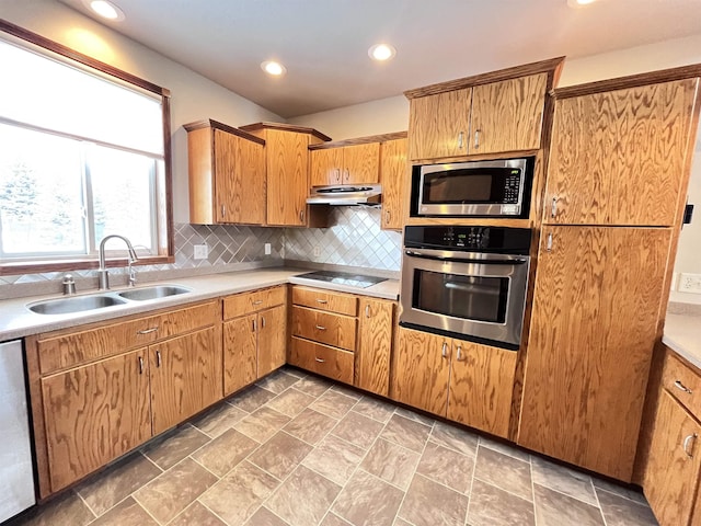 kitchen with stainless steel appliances, tasteful backsplash, and sink