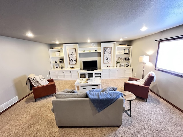 living room featuring light colored carpet and a textured ceiling