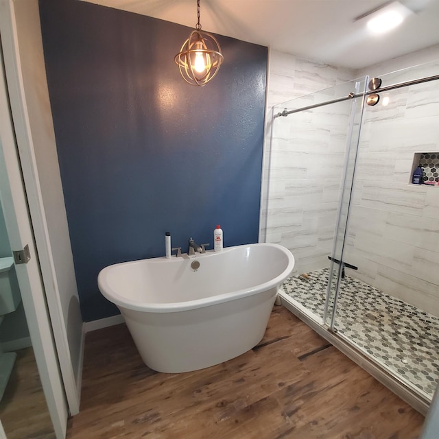 bathroom featuring independent shower and bath and hardwood / wood-style floors