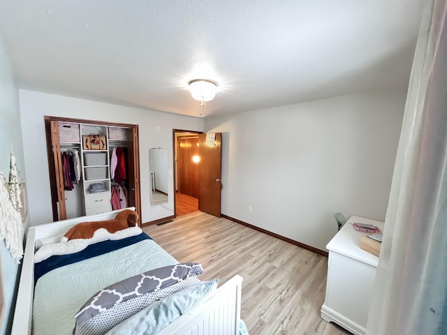 bedroom with a closet and light hardwood / wood-style flooring