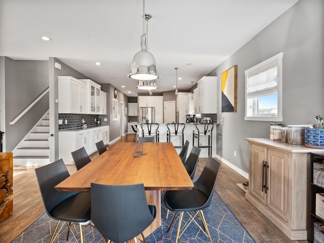 dining space with dark hardwood / wood-style flooring