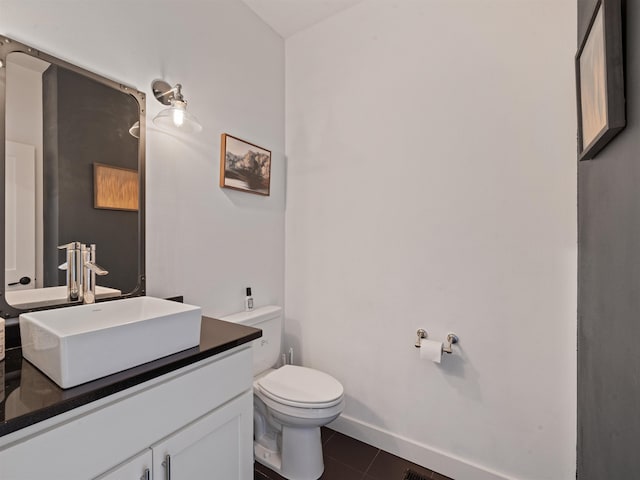 bathroom featuring toilet, tile patterned flooring, and vanity