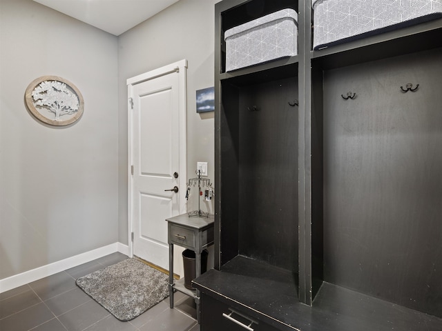 mudroom featuring dark tile patterned floors