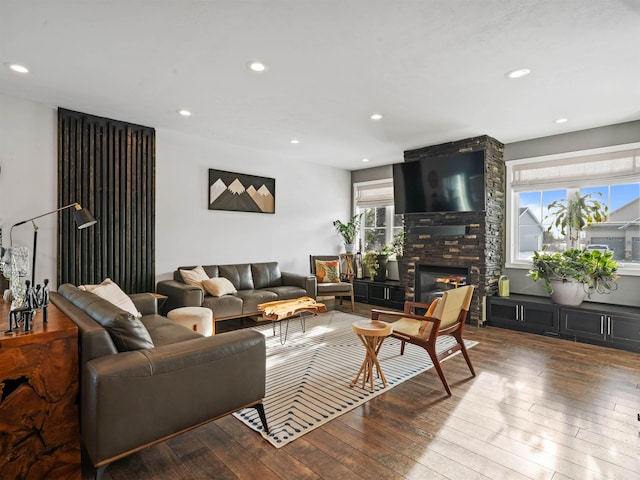 living room featuring hardwood / wood-style floors and a stone fireplace