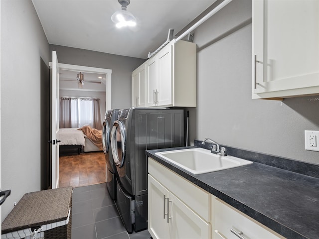 washroom with sink, separate washer and dryer, and cabinets