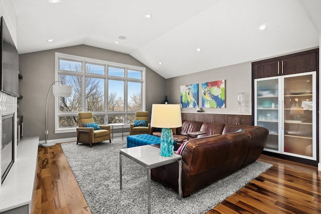 living room featuring vaulted ceiling and dark hardwood / wood-style floors