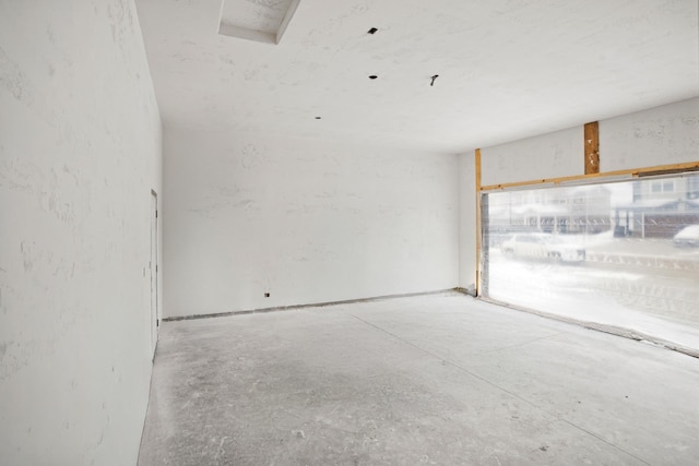 empty room with concrete flooring