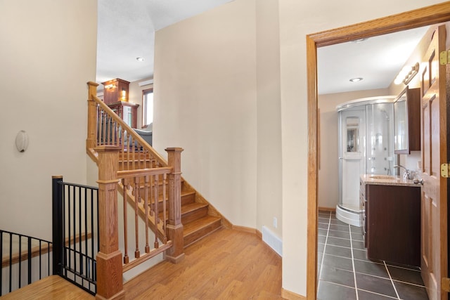 529 Rice Lake Rd, Rice Lake, ND 58735 - staircase featuring hardwood / wood-style flooring and sink