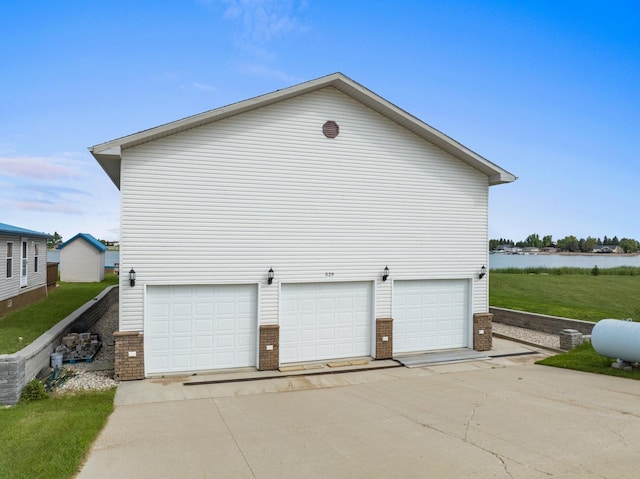529 Rice Lake Rd, Rice Lake, ND 58735 - view of side of home featuring a garage and a water view