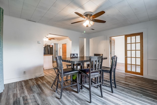 dining space with hardwood / wood-style flooring and ceiling fan