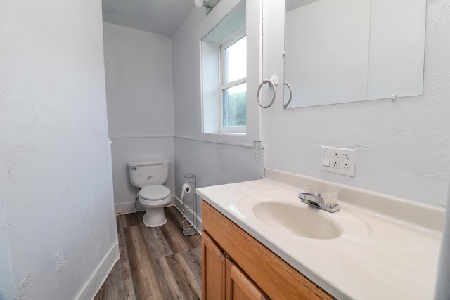 bathroom featuring vanity, toilet, and hardwood / wood-style flooring