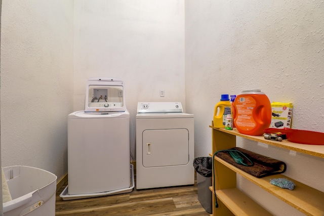 laundry room featuring wood-type flooring and washer and clothes dryer