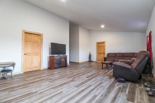 living room featuring high vaulted ceiling and light wood-type flooring