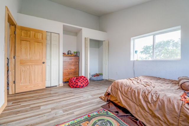 bedroom with light hardwood / wood-style flooring and a closet