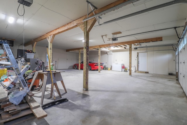 garage featuring washer / clothes dryer and a garage door opener