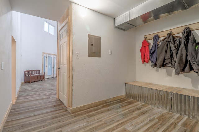 mudroom featuring electric panel and light hardwood / wood-style floors