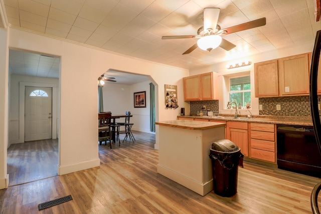 kitchen featuring light brown cabinets, light hardwood / wood-style flooring, tasteful backsplash, butcher block countertops, and black dishwasher