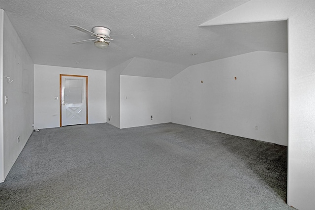 spare room featuring lofted ceiling, a textured ceiling, ceiling fan, and carpet flooring