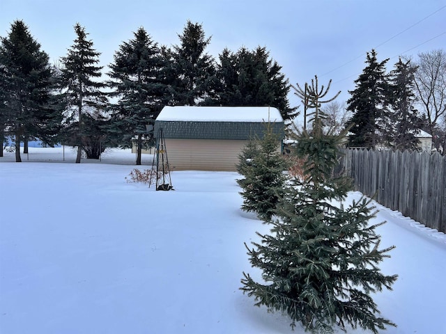 yard covered in snow featuring an outdoor structure