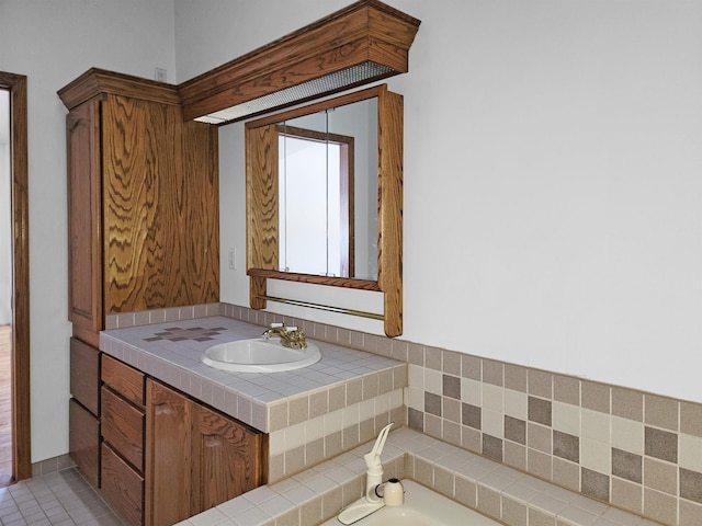 bathroom featuring vanity and a washtub