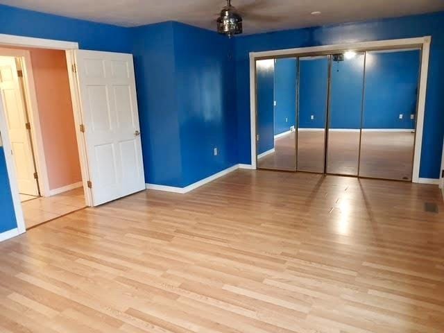 unfurnished bedroom featuring a closet and light hardwood / wood-style floors