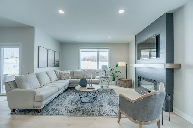 living room featuring a fireplace and light hardwood / wood-style flooring