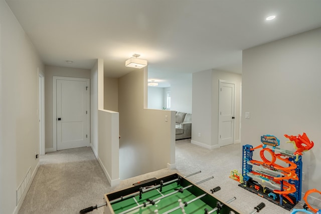 recreation room featuring light colored carpet