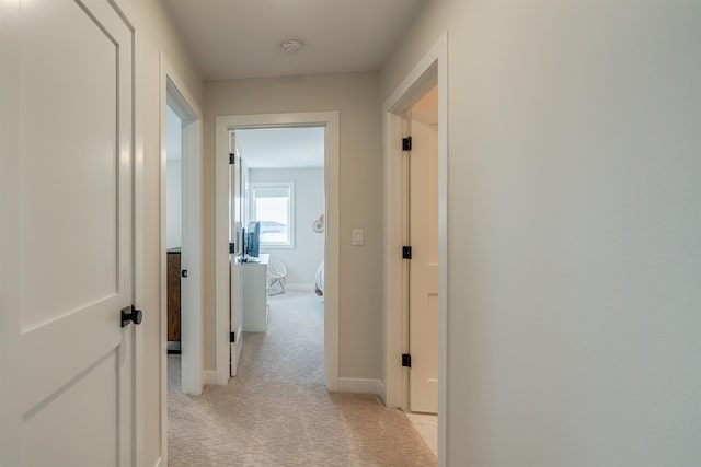 hallway with light colored carpet